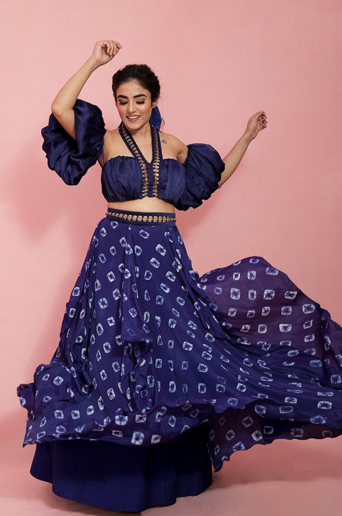 KARIANA : Balloon off shoulder sleeves with Chain texturing neckline paired with a hand knotted tie and dye handkerchief lehenga with chain belt detailing