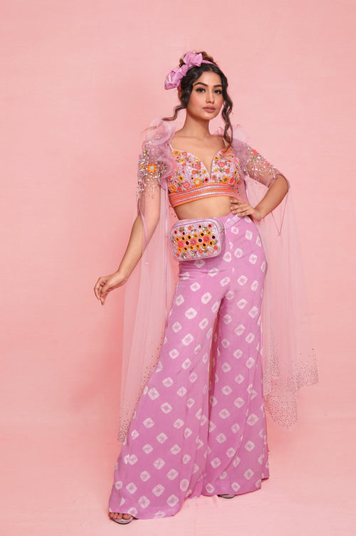 FELI : Organza ruffle collar cape delicately hand embroidered on the shoulders styled with a mirror work embroidered Bikini top, and tie-dye Bell bottom pants