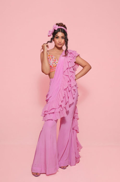 LOYOLA : Ruffle sash concept Saree, styled with a mirror work embroidered Bikini top, ruffle sach draped to look like a saree around Bell bottom pants