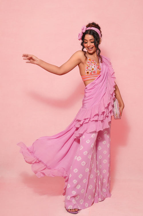 LARA : Ruffle sash concept Saree, styled with a mirror work embroidered Bikini top, ruffle sach draped to look like a saree around hand knotted tie and dyed Bell bottom pants