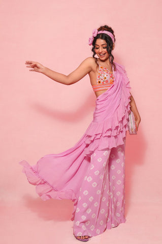 LOYOLA : Ruffle sash concept Saree, styled with a mirror work embroidered Bikini top, ruffle sach draped to look like a saree around Bell bottom pants