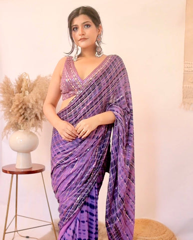 LARA : Ruffle sash concept Saree, styled with a mirror work embroidered Bikini top, ruffle sach draped to look like a saree around hand knotted tie and dyed Bell bottom pants