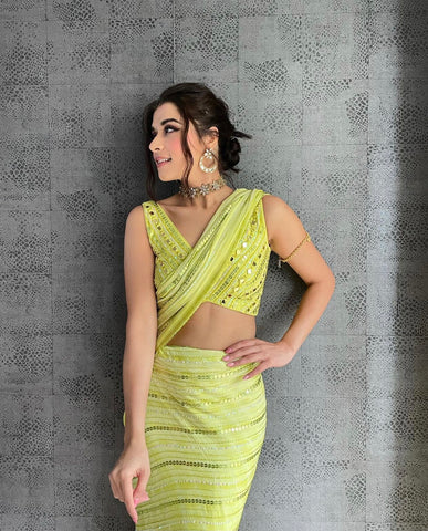 LOYOLA : Ruffle sash concept Saree, styled with a mirror work embroidered Bikini top, ruffle sach draped to look like a saree around Bell bottom pants