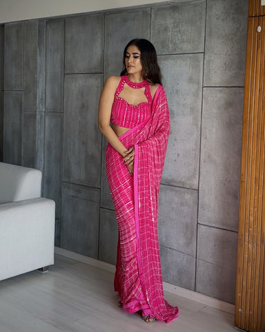 LARA : Ruffle sash concept Saree, styled with a mirror work embroidered Bikini top, ruffle sach draped to look like a saree around hand knotted tie and dyed Bell bottom pants